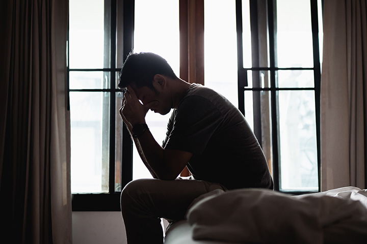 Mann deprimiert sitzt auf Bett